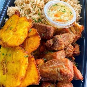 Rice and pigeon beans with fried plantain and fried pork